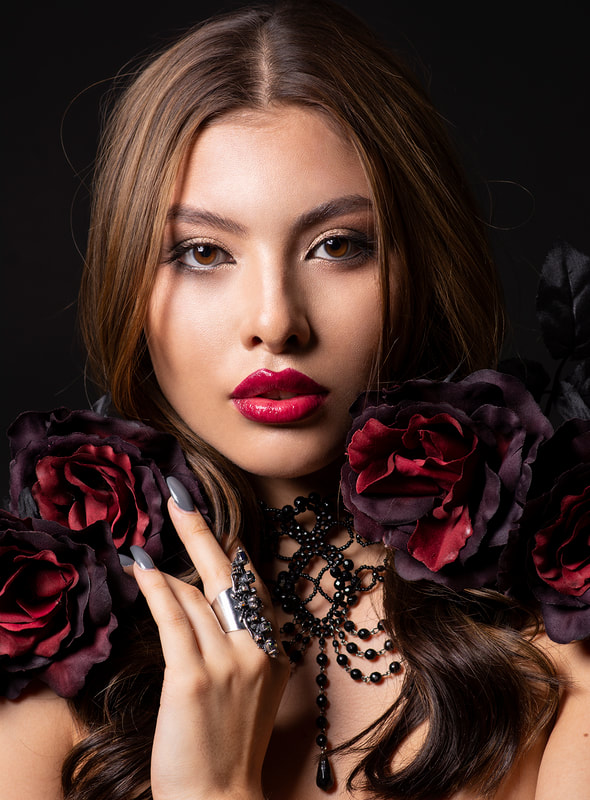 Fashion portrait with red flowers